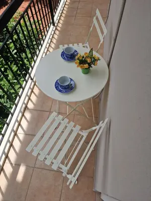 a white table and two chairs on a balcony at The Argy Apartment in Athens