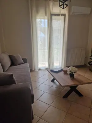 a living room with a couch and a coffee table at The Argy Apartment in Athens