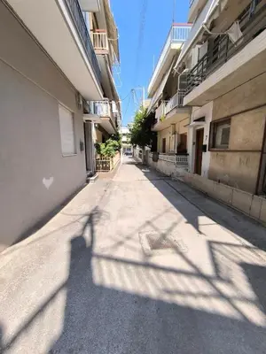 an empty street with a shadow of a building at The Argy Apartment in Athens