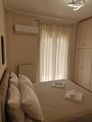 a bedroom with a bed with two towels on it at The Argy Apartment in Athens