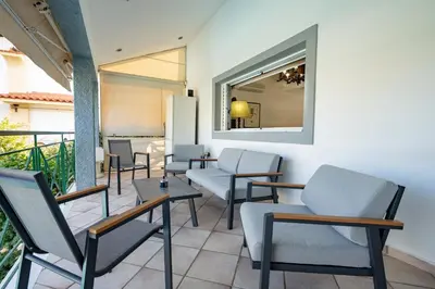 a waiting room with chairs and a mirror at 4 Bedroom Villa with private pool in Lagonisi in Áyios Nikólaos