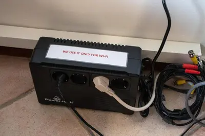 a router with a sign that says we let it comply for wifi at 4 Bedroom Villa with private pool in Lagonisi in Áyios Nikólaos