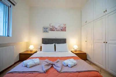 a bedroom with a bed with two towels on it at 4 Bedroom Villa with private pool in Lagonisi in Áyios Nikólaos