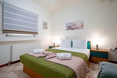 a bedroom with a bed with towels on it at 4 Bedroom Villa with private pool in Lagonisi in Áyios Nikólaos