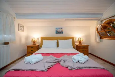 a bedroom with a large bed with towels on it at 4 Bedroom Villa with private pool in Lagonisi in Áyios Nikólaos