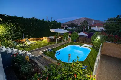 a backyard with a swimming pool in a yard at 4 Bedroom Villa with private pool in Lagonisi in Áyios Nikólaos