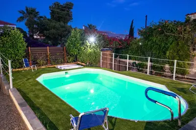 a swimming pool in a yard at night at 4 Bedroom Villa with private pool in Lagonisi in Áyios Nikólaos