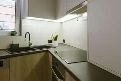 a kitchen with a sink and a window and a counter at Viorelia's Home in Athens