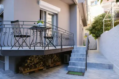 a balcony with a table and stairs in a building at Viorelia's Home in Athens