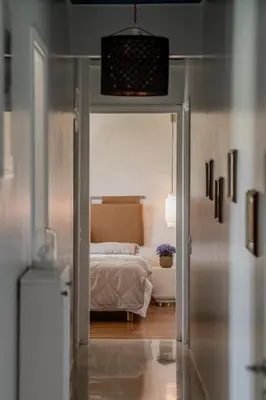 a bedroom with a bed and a door leading to a bathroom at Alimos Marina Home - Luxury Corner SeaView Apartment in Athens