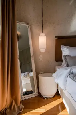 a bedroom with a mirror next to a bed at Alimos Marina Home - Luxury Corner SeaView Apartment in Athens