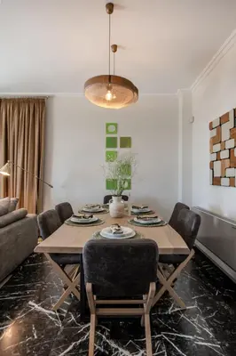 a dining room with a table and chairs at Alimos Marina Home - Luxury Corner SeaView Apartment in Athens