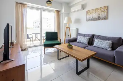 a living room with a couch and a tv at Urban Comfort near Piraeus Port D3 in Piraeus