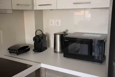 a kitchen counter with a microwave and a toaster at Urban Comfort near Piraeus Port D3 in Piraeus