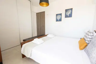 a bedroom with a white bed with towels on it at Urban Comfort near Piraeus Port D3 in Piraeus