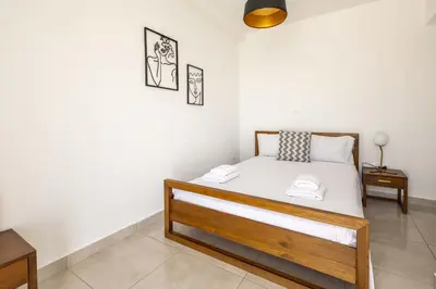 a bedroom with a bed with two towels on it at Waylink Residences-Piraeus Port DRA in Piraeus
