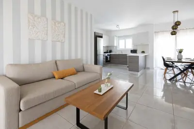a living room with a couch and a table at Waylink Residences-Piraeus Port DRA in Piraeus