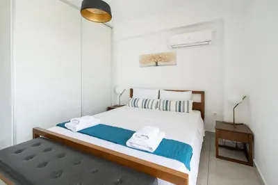 a bedroom with a bed with towels on it at Waylink Residences-Piraeus Port DRA in Piraeus