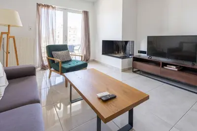 a living room with a tv and a coffee table at Waylink Residences-Piraeus Port DRA in Piraeus
