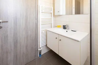 a bathroom with a white sink and a shower at Waylink Residences-Piraeus Port DRA in Piraeus