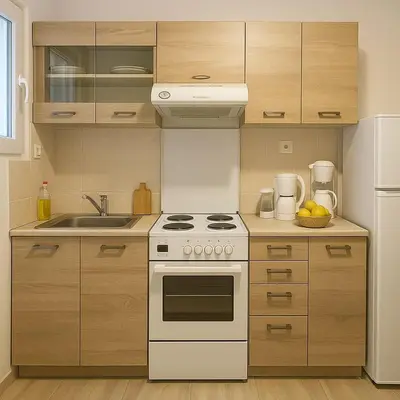 a kitchen with a white stove top oven next to a refrigerator at Lovingly apartment Galatsi 1 in Athens