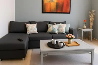 a living room with a couch and a coffee table at Lovingly apartment Galatsi 1 in Athens