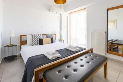 a bedroom with a large bed with towels on it at Modern Stay near Piraeus Port E3 in Piraeus