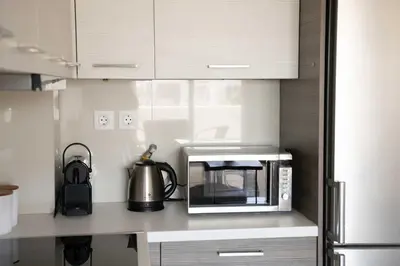 a kitchen with a microwave and a kettle on a counter at Modern Stay near Piraeus Port E3 in Piraeus