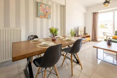 a dining room with a wooden table and chairs at Modern Stay near Piraeus Port E3 in Piraeus