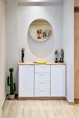 a white dressing room with a mirror and a cactus at Pop Art Apartment in Piraeus in Piraeus