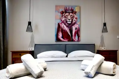 a bed with a painting of a tiger wearing a crown at Pop Art Apartment in Piraeus in Piraeus