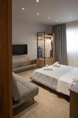 a bedroom with a large bed and a tv at Pop Art Apartment in Piraeus in Piraeus