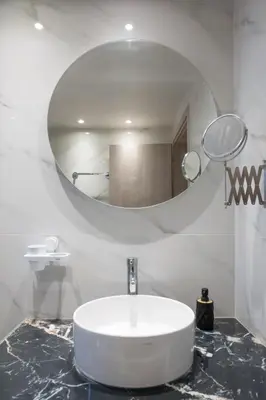 a bathroom with a sink and a large mirror at Pop Art Apartment in Piraeus in Piraeus