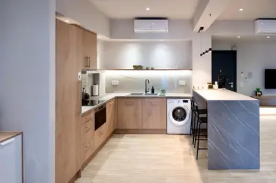 a large kitchen with a washer and dryer in it at Pop Art Apartment in Piraeus in Piraeus