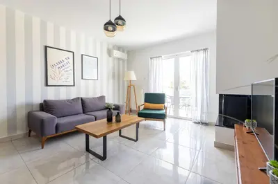 a living room with a purple couch and a table at Modern Apartment in Piraeus Port D2 in Piraeus