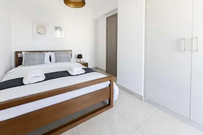 a bedroom with a large bed and a closet at Modern Apartment in Piraeus Port D2 in Piraeus