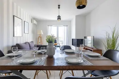 a dining room with a wooden table and chairs at Modern Apartment in Piraeus Port D2 in Piraeus
