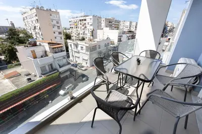a balcony with chairs and a table on a balcony at Modern Apartment in Piraeus Port D2 in Piraeus