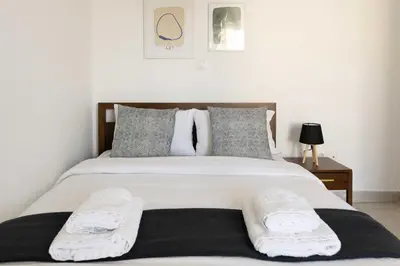 a bedroom with a large white bed with two pillows at Modern Apartment in Piraeus Port D2 in Piraeus
