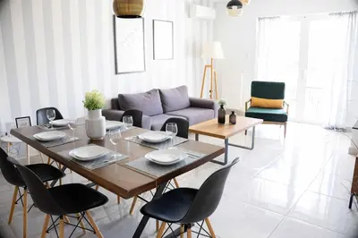 a living room with a table and a couch at Modern Apartment in Piraeus Port D2 in Piraeus