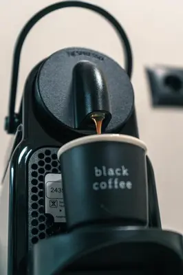 a black coffee pot with a cup in it at Urban Nest in Trendy Koukaki in Athens
