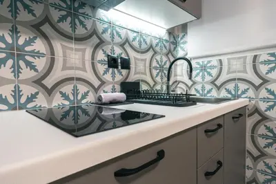 a bathroom with a sink and a tile wall at Urban Nest in Trendy Koukaki in Athens