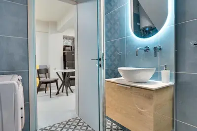 a bathroom with a sink and a mirror at Urban Nest in Trendy Koukaki in Athens