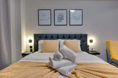 a bedroom with a large bed with towels on it at Urban Nest in Trendy Koukaki in Athens