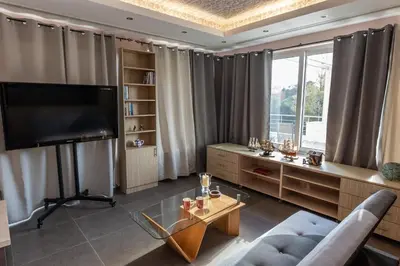 a living room with a large window and a television at Michele Studio in Artemida