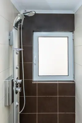 a shower with a window in a bathroom at Michele Studio in Artemida