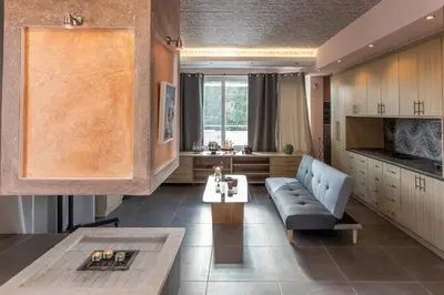 a living room with a couch and a table at Michele Studio in Artemida