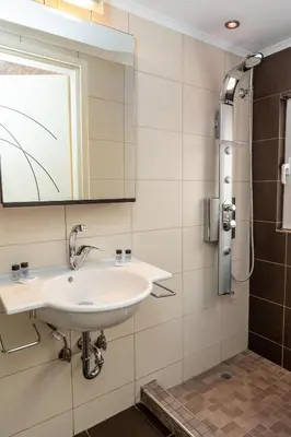 a bathroom with a sink and a mirror at Michele Studio in Artemida