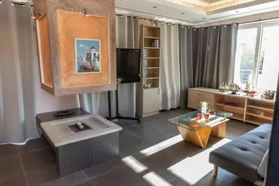 a living room with a couch and a tv at Michele Studio in Artemida