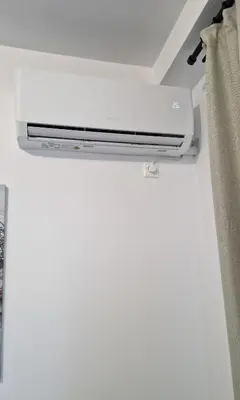 a white air conditioner hanging from a ceiling at Cozy apartment in Athens in Athens